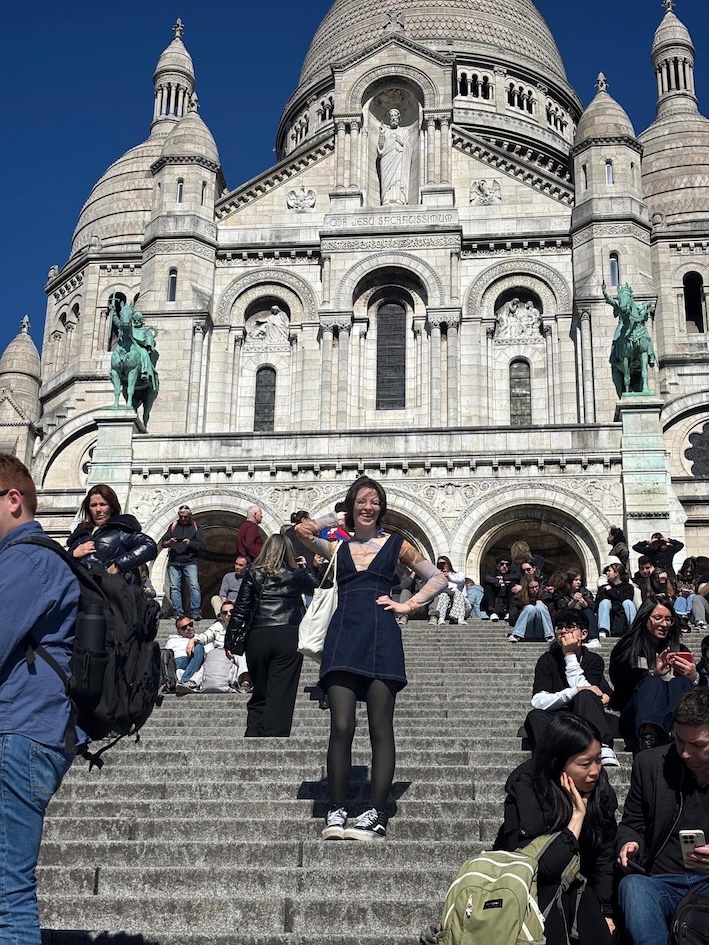 Nathalie standing on a Cathedral's steps