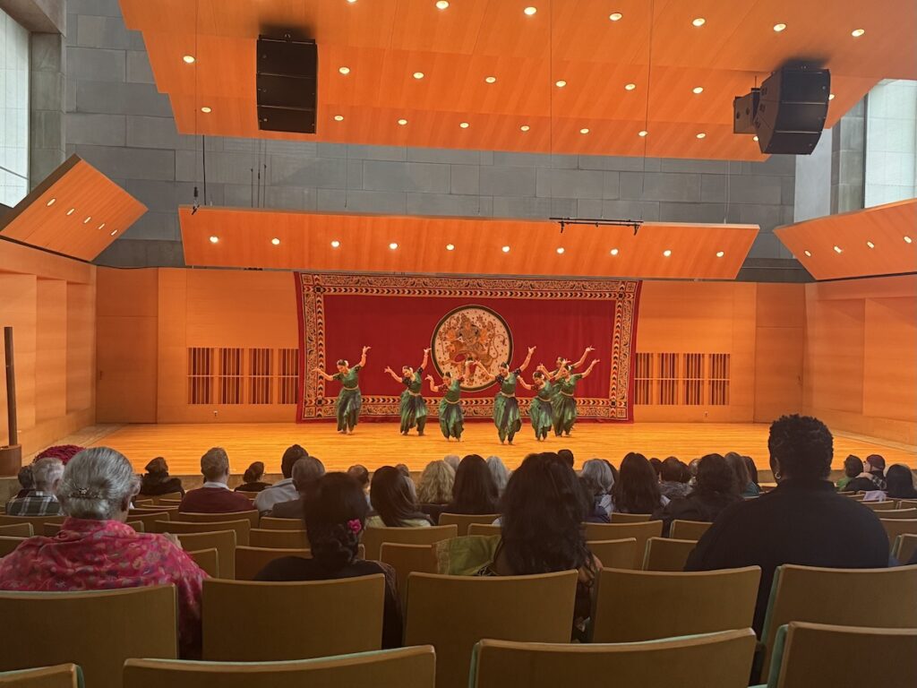 An audience watches dancers performing on stage